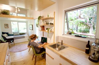 This Midcentury-Inspired Tiny House Radiates Clever Design - Photo 7 of 10 - "We've also ensured there's ample room for clear wall space in sensible locations for televisions and pictures to be hung. We’ve 'future-proofed' the design so that later additions don't crowd the space or look like after-thoughts," says Carter.he front door leads into a tall space where the ceiling goes upward toward a generous feature window.