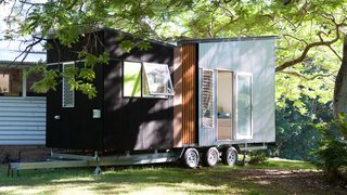 This Midcentury-Inspired Tiny House Radiates Clever Design - Photo 1 of 10 - With a base price of $79,000, this 194-square-foot trailer is a complete tiny house on wheels and offers its owners flexibility of layout, as well as a wide range of optional customizations.