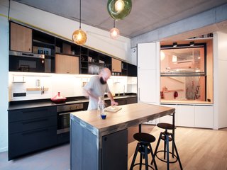 Local carpenters, along with the team at Atelier Pelpell, designed 80 percent of the furniture in the apartment. Transformable pieces, such as a kitchen island with a built-in extendable dining table, were used to maximize functional space.