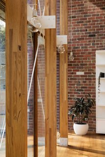 An Airy New Pavilion Lets One Family Practically Live in a Park - Photo 7 of 9 - Elegant ceramic pendant lamps are draped on each post.