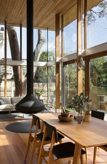 An Airy New Pavilion Lets One Family Practically Live in a Park - Photo 3 of 9 - Timber posts, which support a timber-lined canopy overhead, serve as the boundaries of the pavilion structure. 