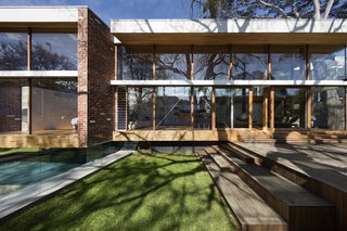 An Airy New Pavilion Lets One Family Practically Live in a Park - Photo 2 of 9 - The existing building was rendered precast at the first floor, seated on clinker bricks.