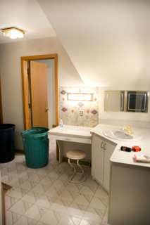 The original bathroom featured a tiny sink and vanity outside the door, as well as a hallway to connect the space to the master bedroom. To create a more spacious atmosphere, Bertolini closed off the hallway so the area could be converted into one large single room.