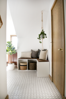 When Bertollini removed the old sink and vanity, she added DIY storage bench seats. Inside each of the bench cubbies are woven baskets that keep miscellaneous items out of view.