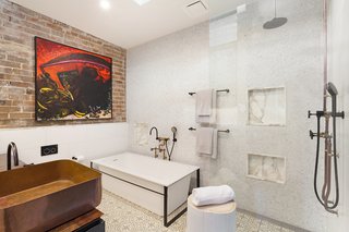 Hand-beaten brass basins and brass plumbing and hardware gleam in the three bathrooms.