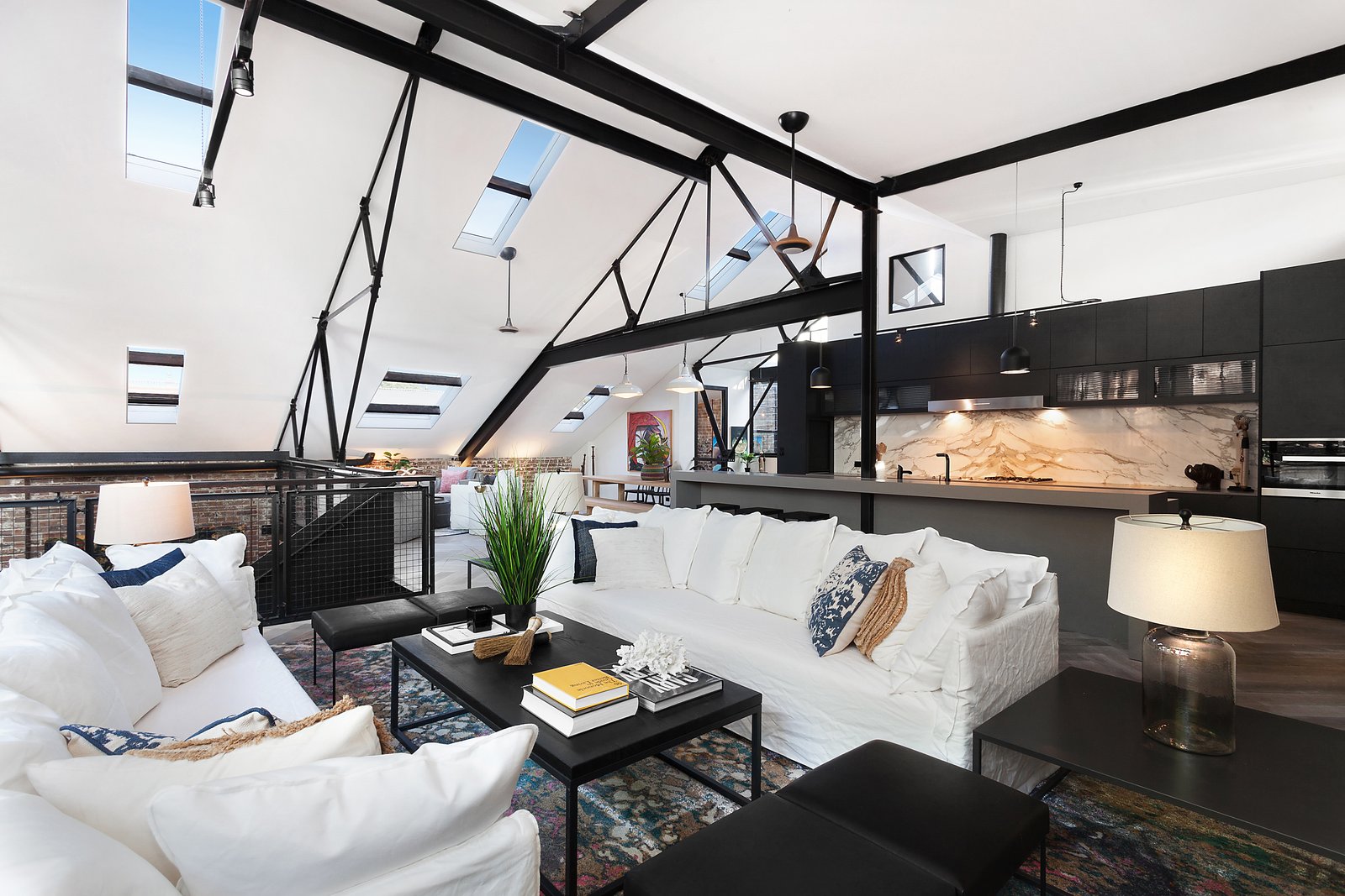 The living area on the upper level leads out to a rooftop terrace.