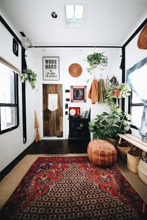 Autumn decorated the toy hauler with Persian rugs, which she bought on eBay for $99 each. She also incorporated poufs and woven flat baskets that she "borrowed" from her mother.