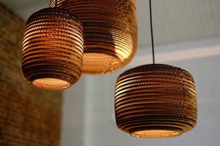 Made of recycled corrugated cardboard, the Scraplight series of pendent lamps by Seattle design studio Graypants Inc. can be used with low-energy 12.5-watt Philips LED bulb for lighting that is both green and efficient. 