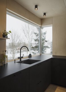 The kitchen looks out to woodland views.