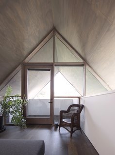 The window system, which was built on site, repeats the simple vernacular geometry of the exterior. 
