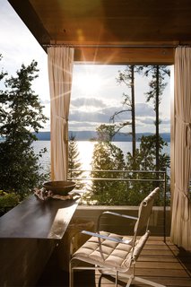 This rustic Montana retreat has a green roof that looks like part of the hillside.