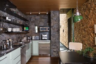 Natural materials such as concrete, stone, and wood give the architecture a rugged honesty that allows it to harmonize with the pine trees and stone outcroppings outdoors.
