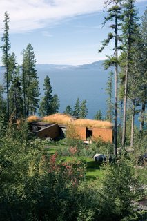 The heart of the camp is the main residence, the Lake House, which has a stacked "cordwood wall" made from Douglas firs found on-site. 