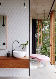  The glazed vertical panels have fine, black silicone lines that define the joints, and solid rosewood frames around the operable windows. 