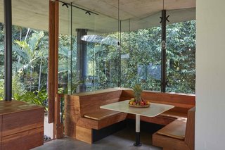 In the kitchen, a built-in timber breakfast booth is the perfect spot to enjoy the dappled morning sunlight.