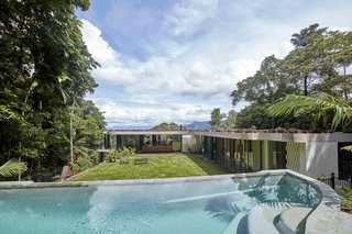 Behind the home, a glade facing northeast offers a protected outdoor oasis set within the rainforest ridge with a magnesium-filtered, above-ground pool. 