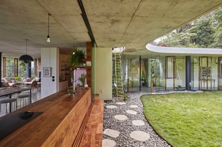 A rosewood bench in the kitchen folds to form an outdoor seat.