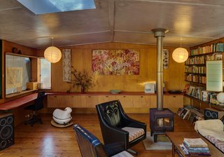 In the light-filled living area, bookcases and two built-in desks help create a workspace.