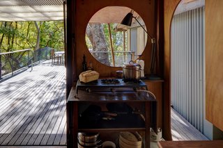 Behind the kitchen pavilion is an open area with a polycarbonate roof.