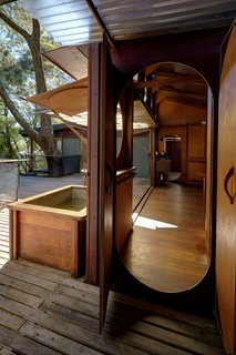 Nautical design inspires the construction of the kitchen, where doorways are elliptical with simple brass handles. 