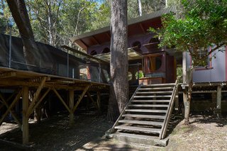 This expansive raised deck, which is accessible from the ground level via a short flight of steps, functions as the main living area and heart of the house. 