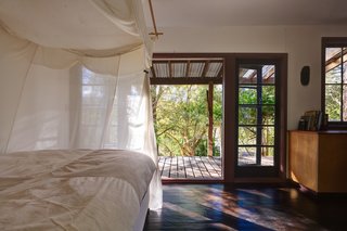 A second bedroom was created with netting surrounding the bed, rug, and built-in storage. 