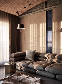 More masculine design elements and a darker color scheme express the style preferences of the husband in the main living area. 