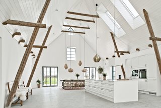 The 4,198-square-foot home features rustic wooden beams that pay homage to the heritage of the buildings. These are set across the soaring 22-foot high ceilings. 