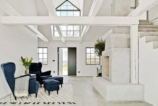 Poured concrete floors and crisp, white plastered walls have been used to give the interiors a bright and fresh look. 