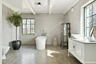 The interiors consist of a large living room and kitchen, along with seven other rooms, four of which are designated as bedrooms. Here is a closer look at one of the bathrooms.