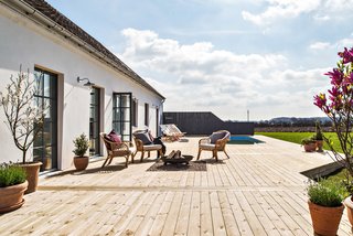 The patio features plenty of space, and includes a pool and fire pit.
