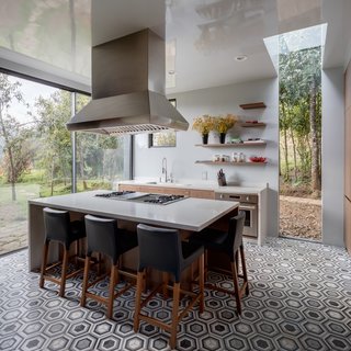 Black-and-white walls, polished basalt floors, and oak ceilings give the interiors a simple, pared-back aesthetic that allow the nature outdoors to take center stage.