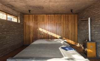 The concrete soffits were left unplastered, and the fly ash walls were finished with just a coat of paint to create an atmosphere of rustic simplicity. 