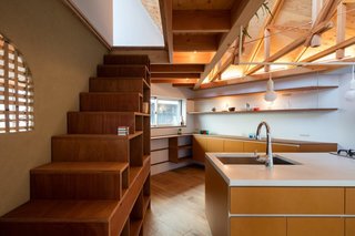 On the second level is a large, open-plan living room, dining room, and kitchen.