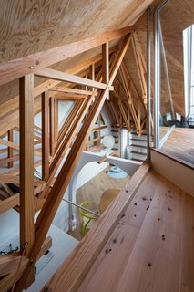 The diagonal positioning of the interior walls enhances the sense of depth within the indoor spaces. 