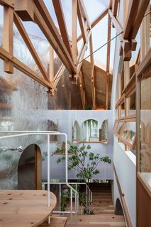 A wooden truss structure supports the beam of the large roof and the exterior walls.