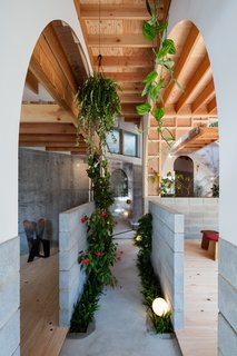 The building houses a workshop with two studios on the ground level and a residence on the upper level. 