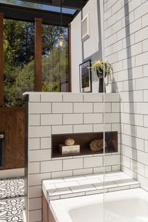 The wall without windows has a sun spotted ceramic tile dado with oak planks above it. 