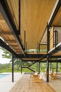 The outdoor dining and lounge area flows out toward the pool.