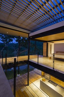The bedrooms and bathrooms are enclosed in areas behind the terraces.