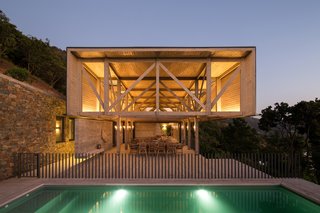 On the lower level is a fully-glazed living and dining space that leads to an outdoor pool and terrace area. 