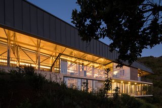 Set on the lower section of the slope, the second volume has a more modern facade, featuring concrete, steel, and glass materials.