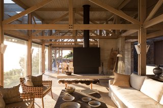 This lower volume features a series of light-filled patios. It also houses the main living areas, which are located under a wooden pavilion. 