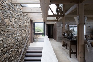 A material palette of concrete, wood, stone, and marble both contrast and complement the native sclerophyll trees around the site.