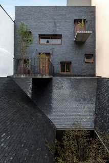 A 13-foot, cantilevered balcony extends from a second-floor bedroom; a third-floor balcony also enjoys a concrete balcony.