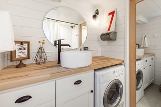 A large oval mirror makes the bathroom look and feel larger.