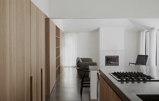 The bedrooms and the bathroom are located within the fold of the V-shaped section, and are separated from the common area by a dividing wall. 
