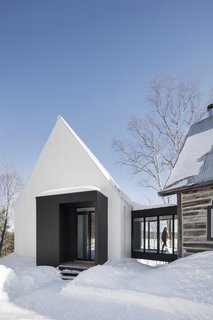 The ribbed texture of the facade echoes the whitewashed walls of the area’s rural barns.