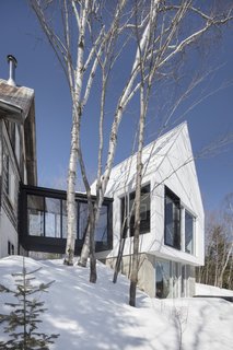 The new addition consists of a white prism that rests atop a concrete pedestal. 