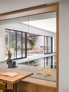 Elements such as the wood joists, wood columns, concrete floors, and machinery from the original building were salvaged and incorporated into the living spaces of the new residence. 